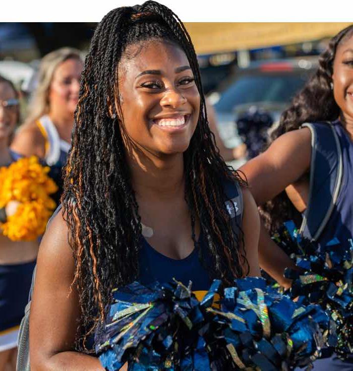 ETAMU Cheerleader smiling at the camera.